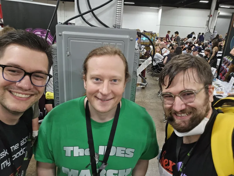 Three handsome men posing for the camera.